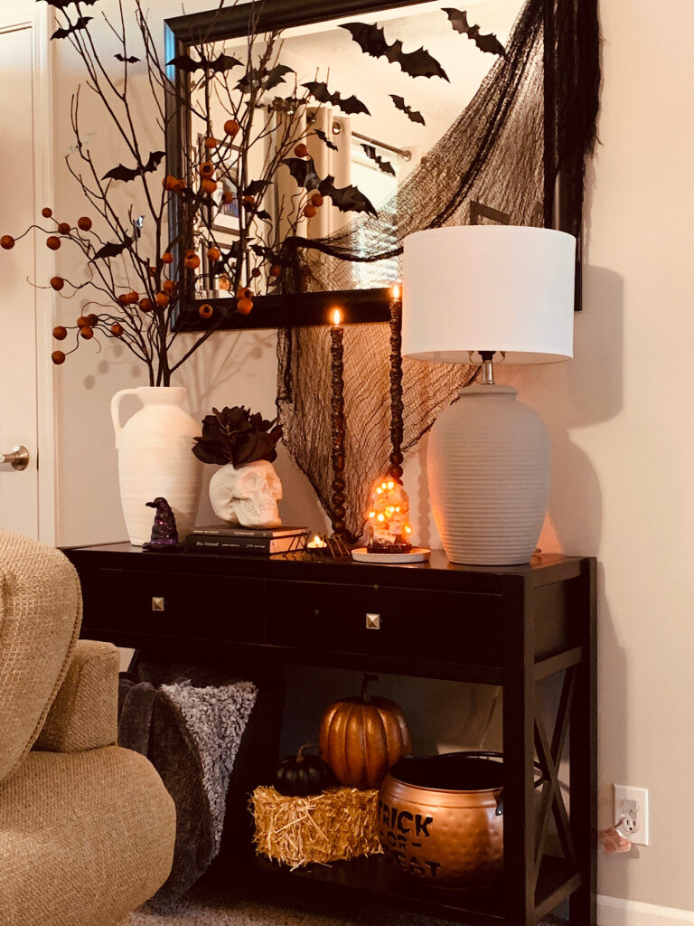 Entryway table Halloween styling with bat branches